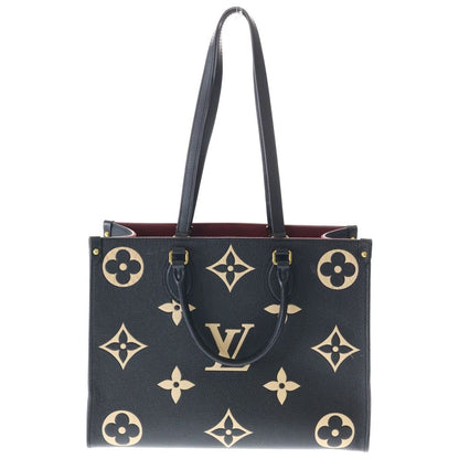 Louis Vuitton On The Go MM Monogram Empreinte Bicolor Leather Hand Tote Gold